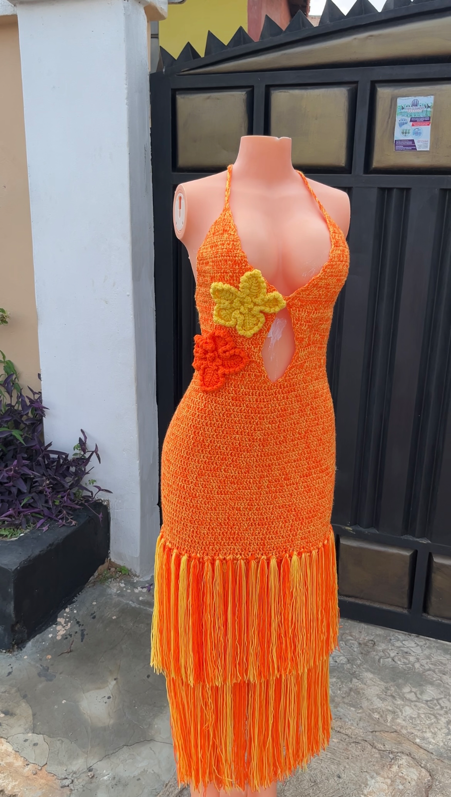 Crochet gown with fringes.